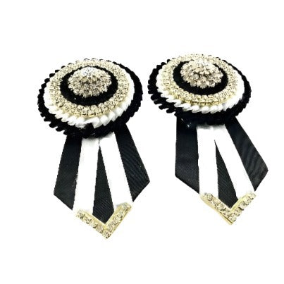 Detailed image of versatile rosettes in monochrome colors, crafted from high-quality materials and designed for effortless attachment to equestrian equipment.