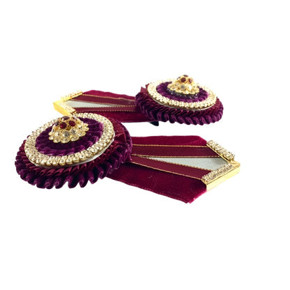 Detailed image of burgundy rosette add-ons, crafted from high-quality materials and designed for easy attachment to equestrian equipment.